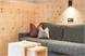 Wohnraum in Zirbe Natur und Altholz mit Doppelbett-schlafchouch
