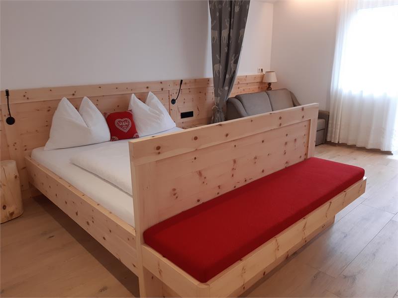 Schlafzimmer in Zirmholz massiv, angehmes Ambiente durch blendfreise indirekte Beleuchtung