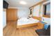 Triple room with wooden floor or carpet and balcony