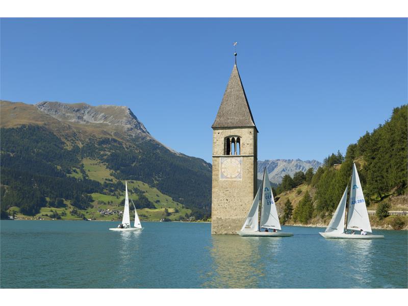 Sailboats on the tower in the lake Reschensee