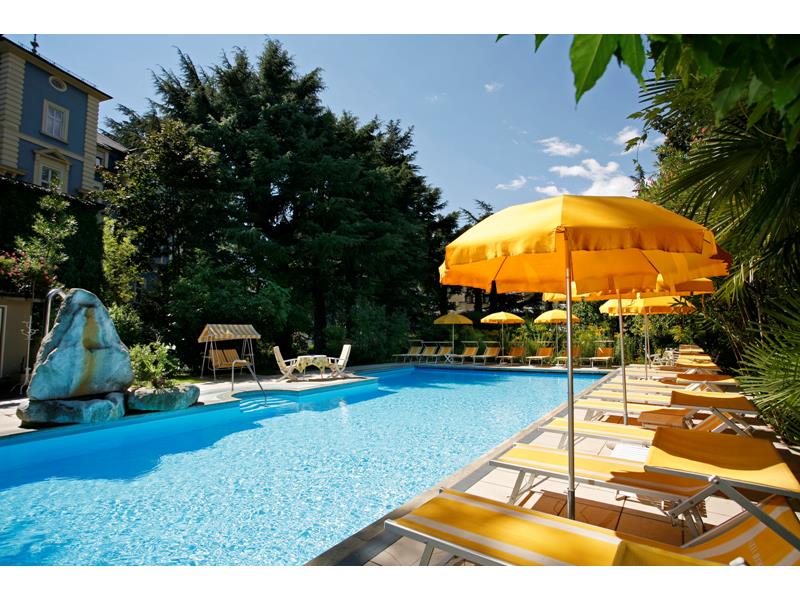 Outdoor pool in the garden with deck chairs